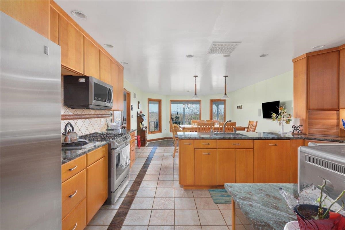 209 Park Ridge Court Front Royal, VA 22630 - Photo 13 of 59 a large kitchen with kitchen island granite countertop a sink a counter top space and cabinets