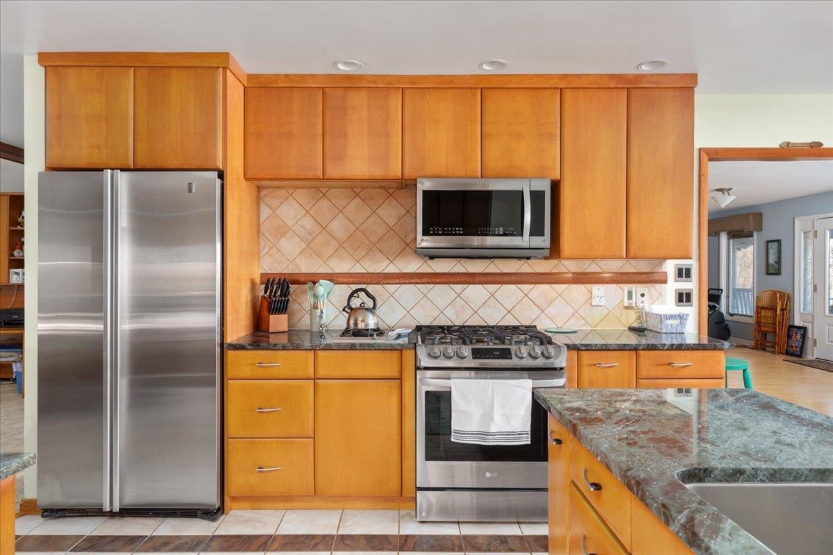 209 Park Ridge Court Front Royal, VA 22630 - Photo 14 of 59 a kitchen with stainless steel appliances granite countertop a refrigerator a stove and a sink with wooden floor