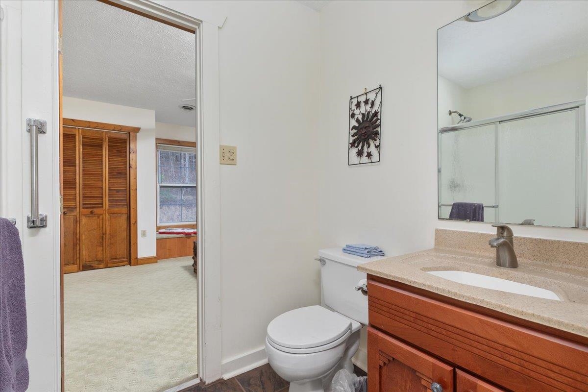 209 Park Ridge Court Front Royal, VA 22630 - Photo 27 of 59 a bathroom with a granite countertop toilet sink and a mirror