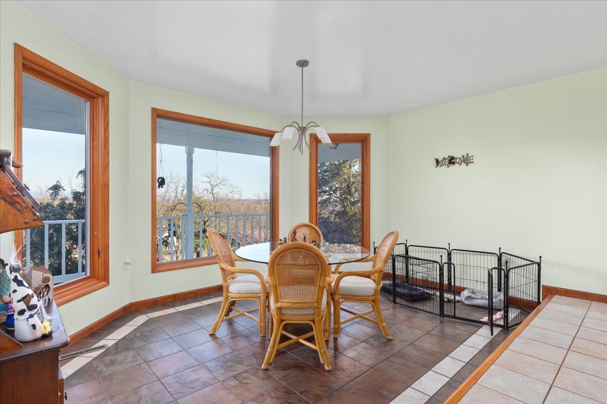 209 Park Ridge Court Front Royal, VA 22630 - Photo 10 of 59 a dining room with furniture a chandelier and wooden floor