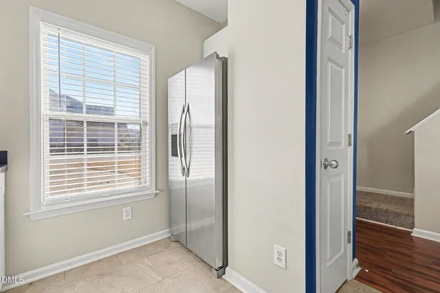 a kitchen with granite countertop white cabinets and stainless steel appliances