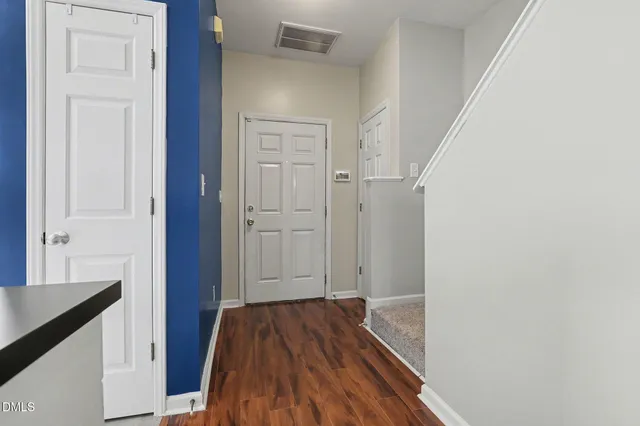 a living room with a fireplace and a wooden floor