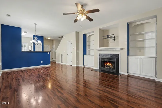 a view of a big room with wooden floor and a ceiling fan