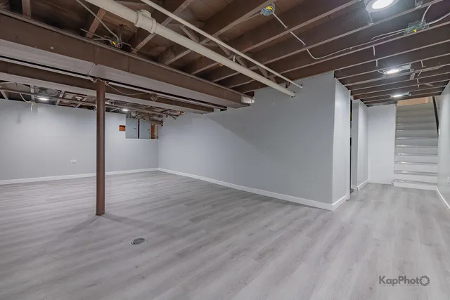 a view of a room with wooden floor