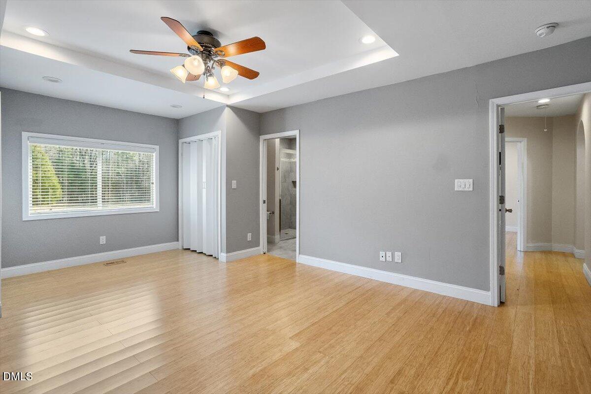 2903 Neville Road Chapel Hill, NC 27516 - Photo 18 of 47 an empty room with wooden floor and windows