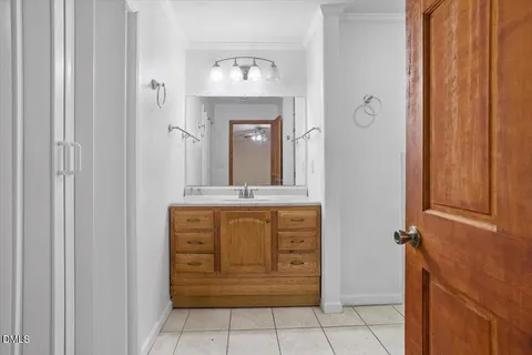 a view of bathroom with a mirror and a sink
