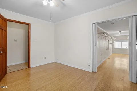 a view of a hallway with wooden floor