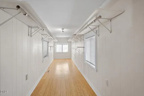 a view of a hallway with wooden floor