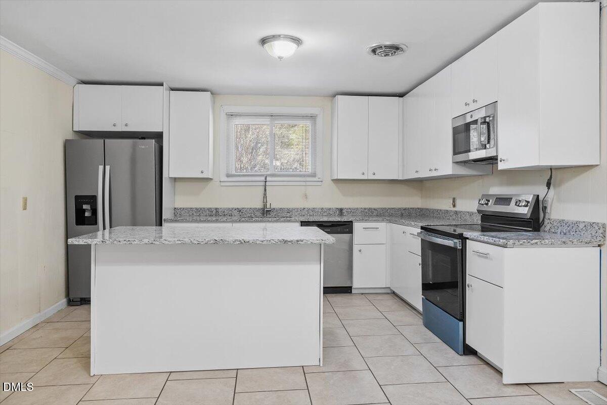 2903 Neville Road Chapel Hill, NC 27516 - Photo 32 of 47 a kitchen with cabinets and stainless steel appliances