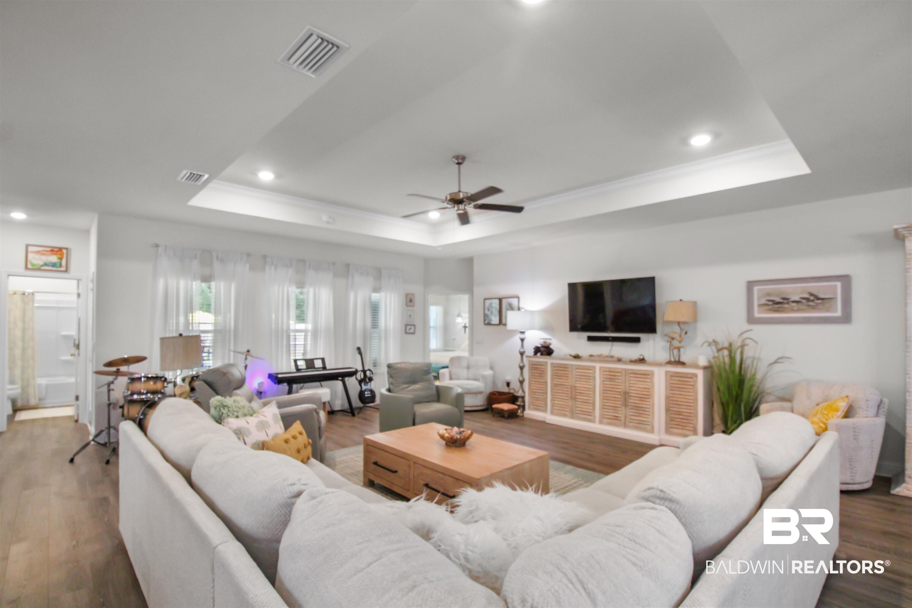 1885 Carly Street Foley, AL 36535 - Photo 14 of 40 Spacious living area featuring wood-finish flooring and a recessed ceiling with crown molding