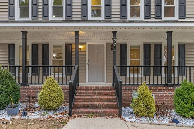 a view of a room with wooden floor a ceiling fan and windows