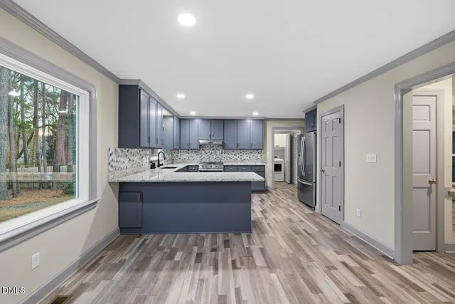 a backyard of a house with table and chairs