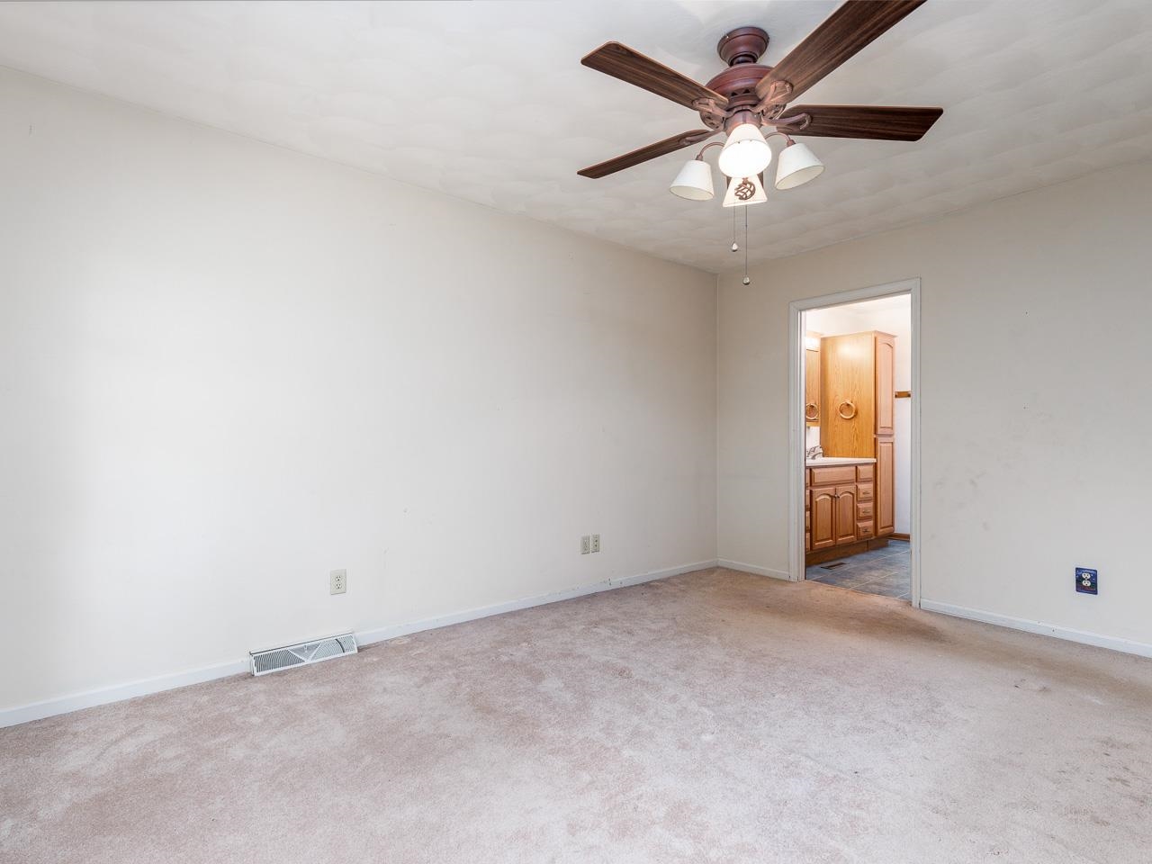 1476 Chadbourne Drive Lake Summerset, IL 61019 - Photo 14 of 22 an empty room with a chandelier fan and windows