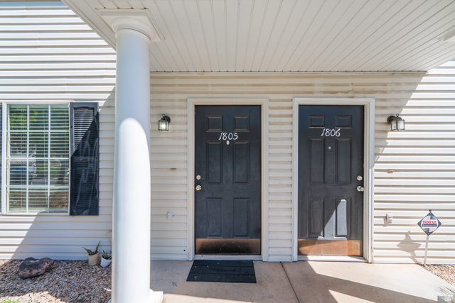 1735 West 540 North, Unit 1805 St. George, UT 84770 - Photo 5 of 64 Exterior facade featuring cream-colored horizontal siding, a white column, and two dark paneled entry doors with house numbers
