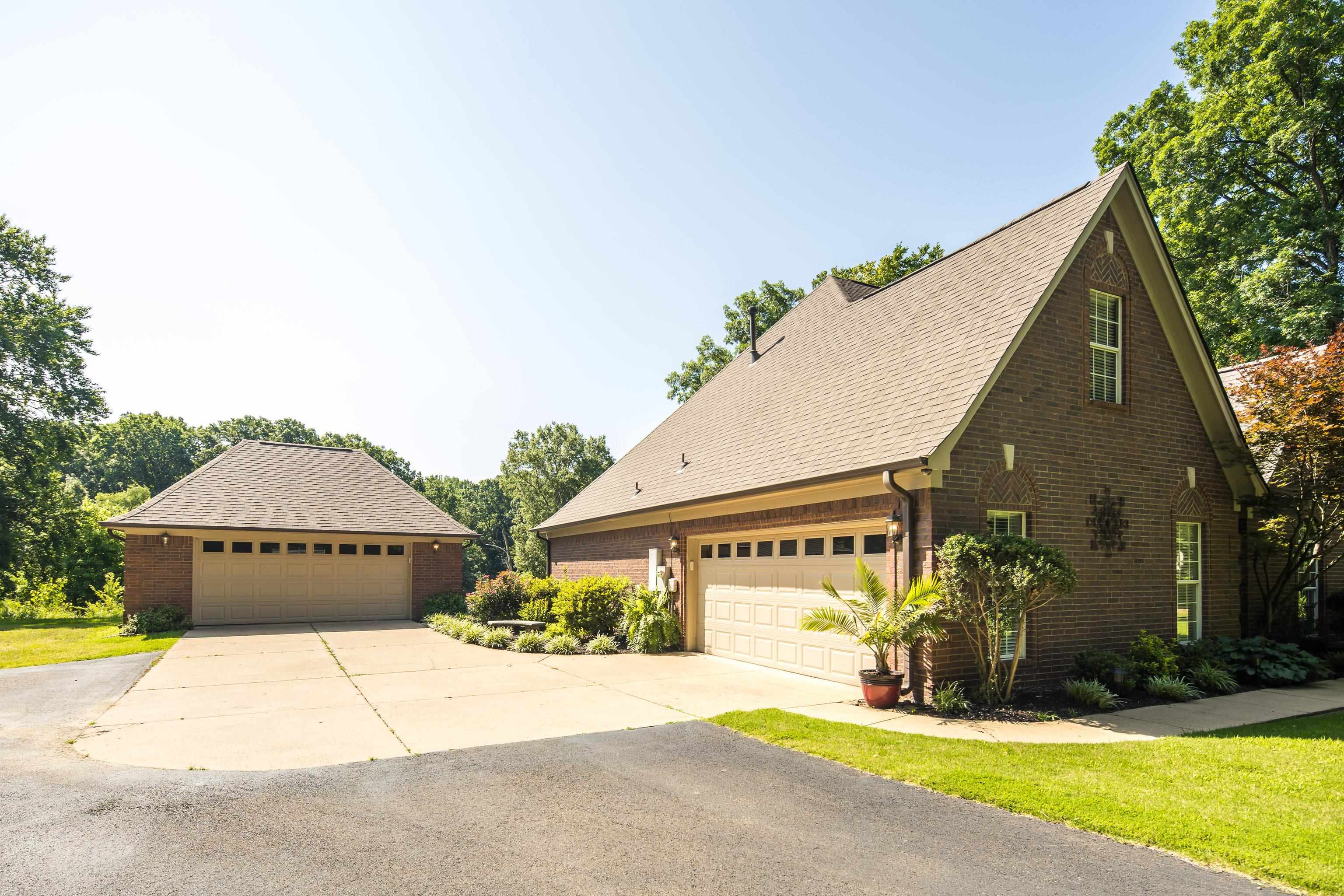 243 Hayes Road Munford, TN 38058 - Photo 20 of 25 Property features plenty of parking due to large concrete and paved driveway area between a side entry 2 car garage and a detached 2 car garage.