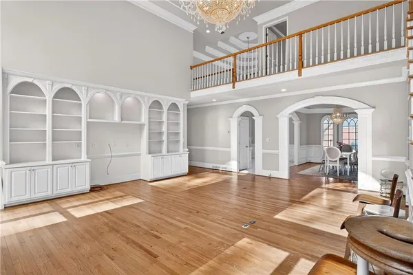 a view of a livingroom with furniture staircase and kitchen view