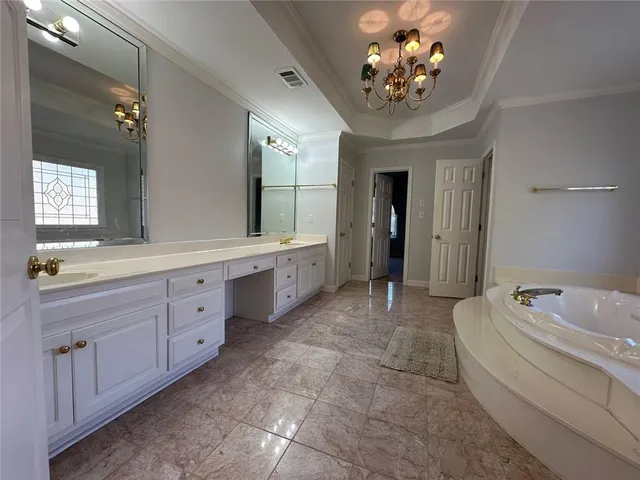 a spacious bathroom with a double vanity sink mirror and double