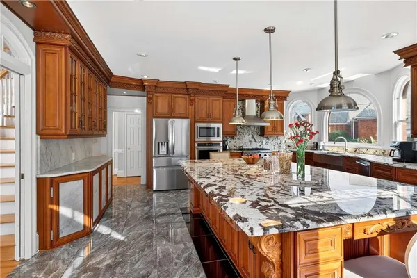 a dining room with a sink a window and chairs