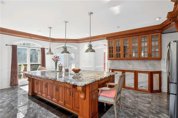a view of an empty room with wooden floor and a fireplace