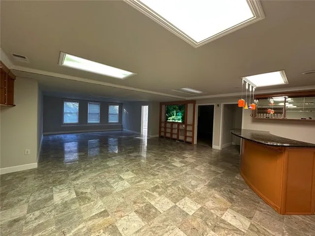 a view of a water heater room with a sink