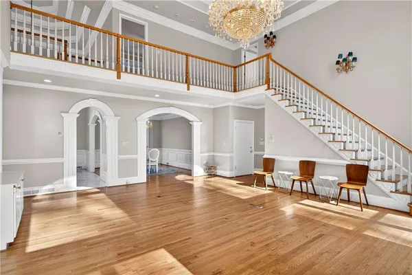 an empty room with a windows and ceiling fan