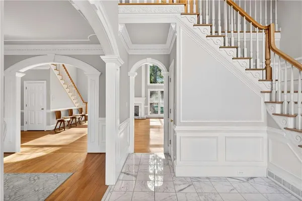 a view of entryway and hall with wooden floor