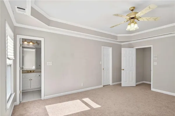 an empty room with windows and fireplace