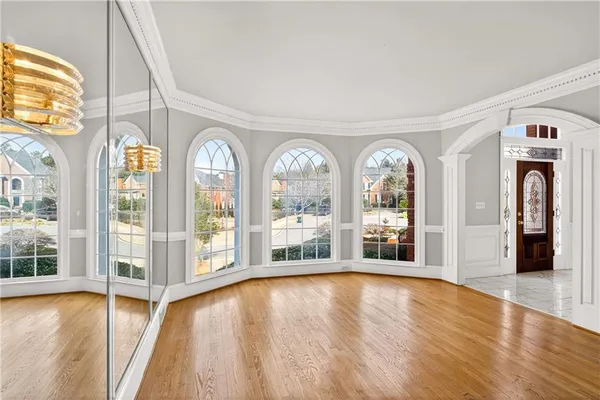 a view of an entryway with wooden floor and door