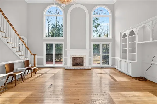 a view of a livingroom with wooden floor and furniture