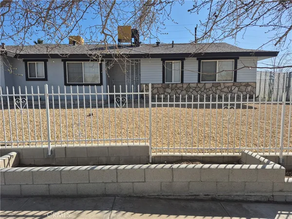 a view of a house with a wooden fence