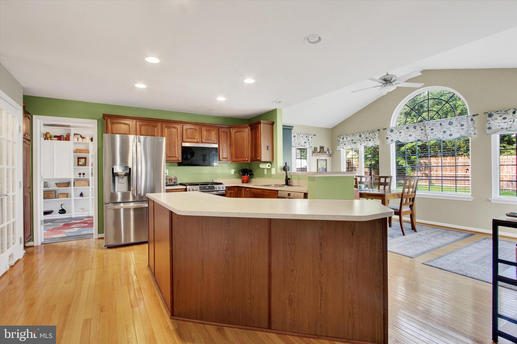 2523 Codorus Lane Spring Grove, PA 17362 - Photo 12 of 53 a kitchen with stainless steel appliances granite countertop a refrigerator a sink dishwasher a stove and a dining table with wooden floor
