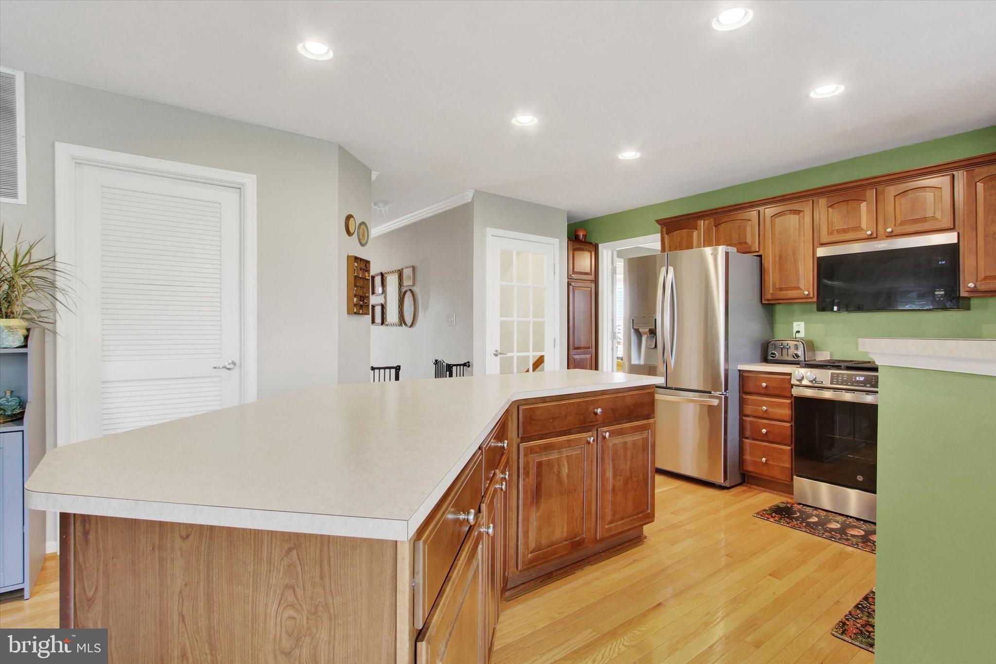 2523 Codorus Lane Spring Grove, PA 17362 - Photo 13 of 53 a kitchen with refrigerator a stove a sink dishwasher and wooden cabinets with wooden floor