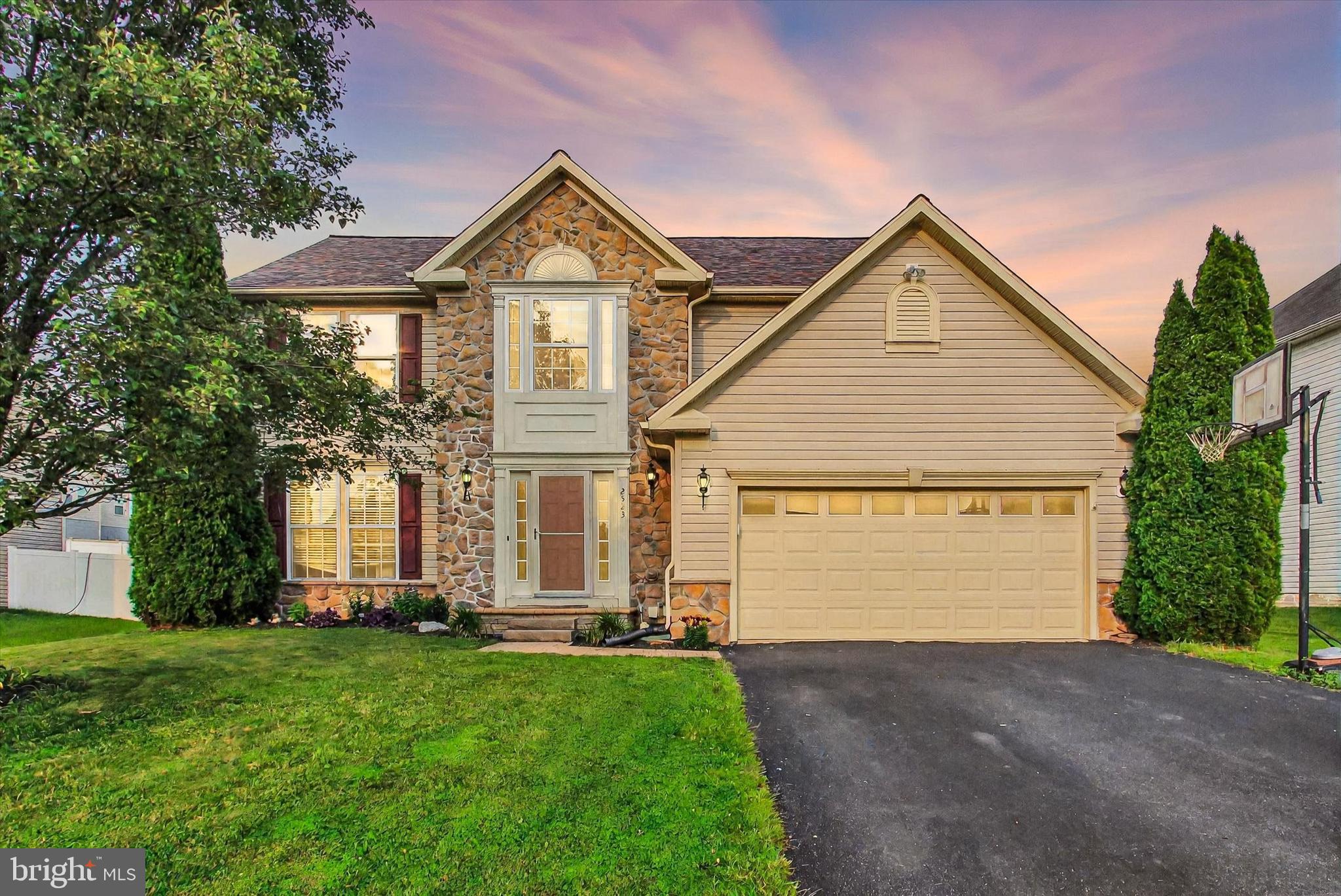 2523 Codorus Lane Spring Grove, PA 17362 - Photo 49 of 53 a view of a house with a small yard and a large tree