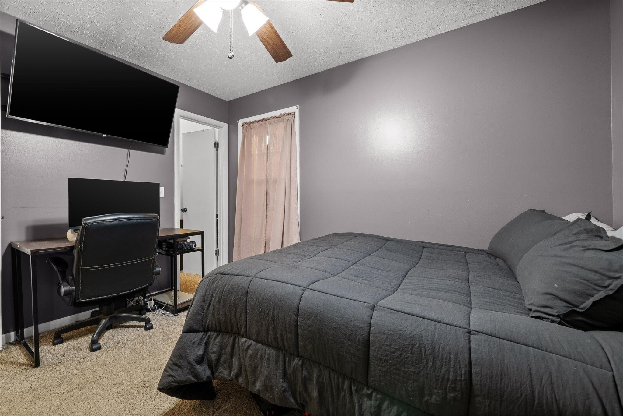 138 Sunset Drive Whitwell, TN 37397 - Photo 14 of 46 a bedroom with a bed a flat screen tv and a chandelier