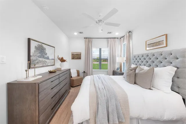 a bedroom with a large bed and a window