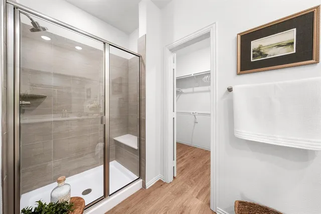 a bathroom with a glass shower door