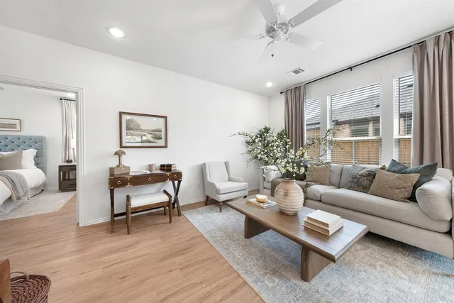 a living room with furniture potted plant and window