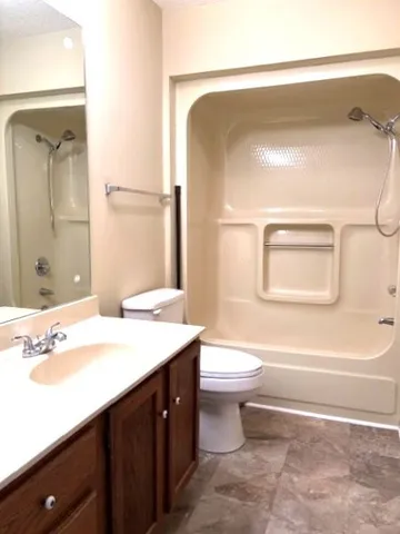 a bathroom with a sink a toilet and a mirror