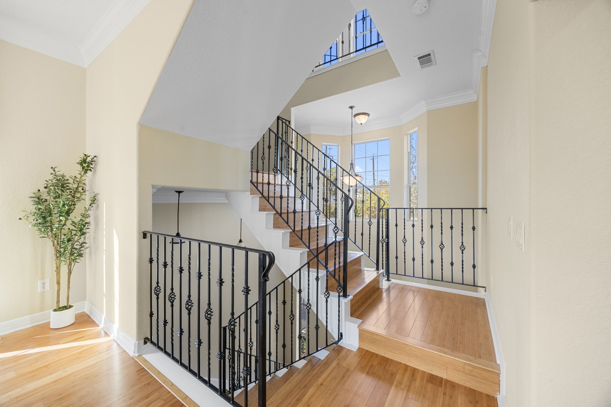 609 Gardner Street Houston, TX 77009 - Photo 15 of 31 a view of staircase with railing and a window