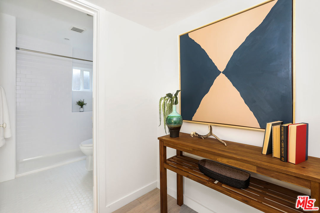3922 Roderick Road Los Angeles, CA 90065 - Photo 21 of 29 a view of a hallway with wooden floor and a bathroom