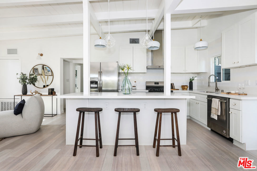 3922 Roderick Road Los Angeles, CA 90065 - Photo 3 of 29 a kitchen with white cabinets and stainless steel appliances