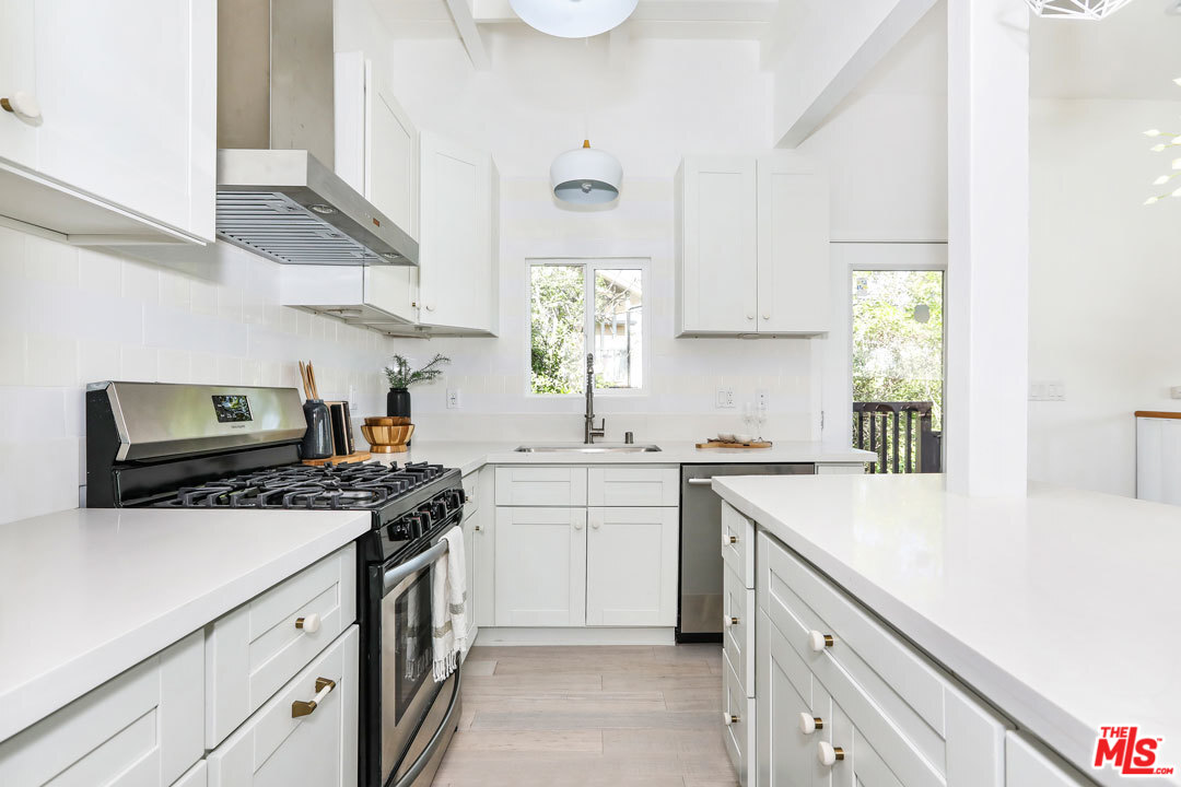 3922 Roderick Road Los Angeles, CA 90065 - Photo 4 of 29 a kitchen with a sink stove and microwave