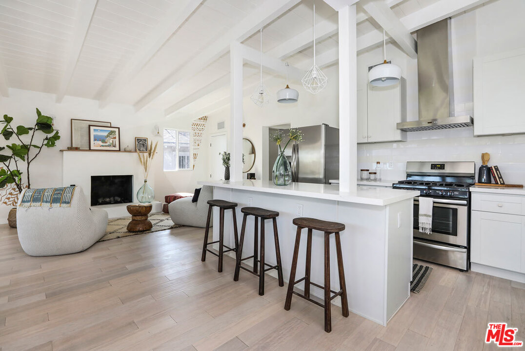 3922 Roderick Road Los Angeles, CA 90065 - Photo 5 of 29 a open kitchen with white cabinets and stainless steel appliances