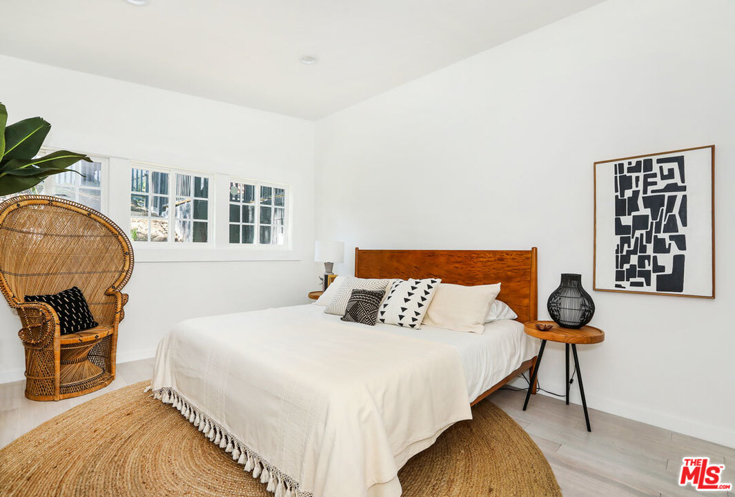 3922 Roderick Road Los Angeles, CA 90065 - Photo 10 of 29 a bedroom with a bed and wooden floor