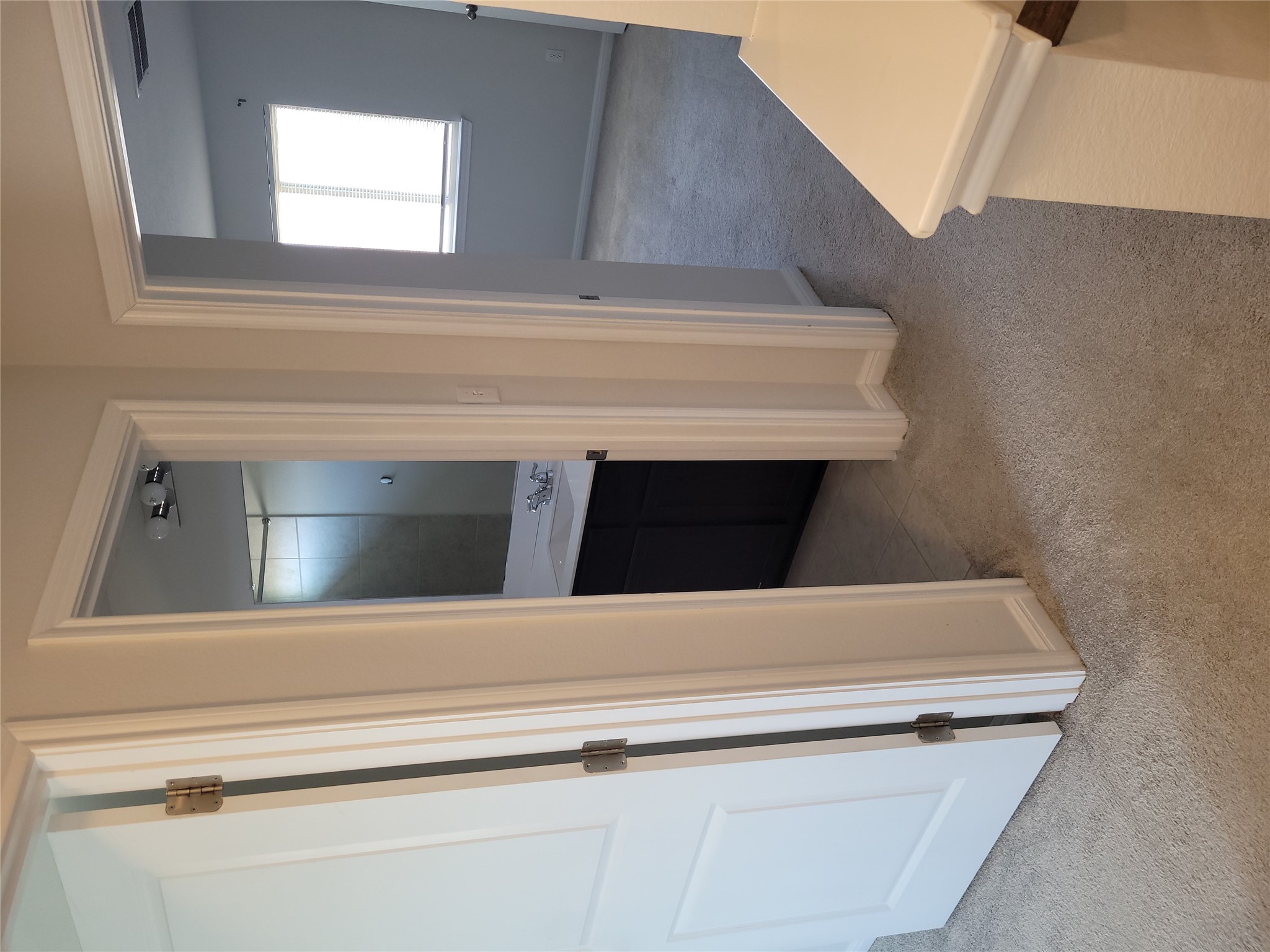 8308 Daisy Cutter Crossing Georgetown, TX 78626 - Photo 14 of 27 A well-lit landing area connects a bright bedroom and a functional bathroom.
