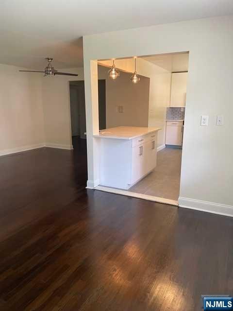 280-320 Oak Street, Unit 290D Ridgewood, NJ 07450 - Photo 6 of 20 a view of a hallway with wooden floor and cabinet