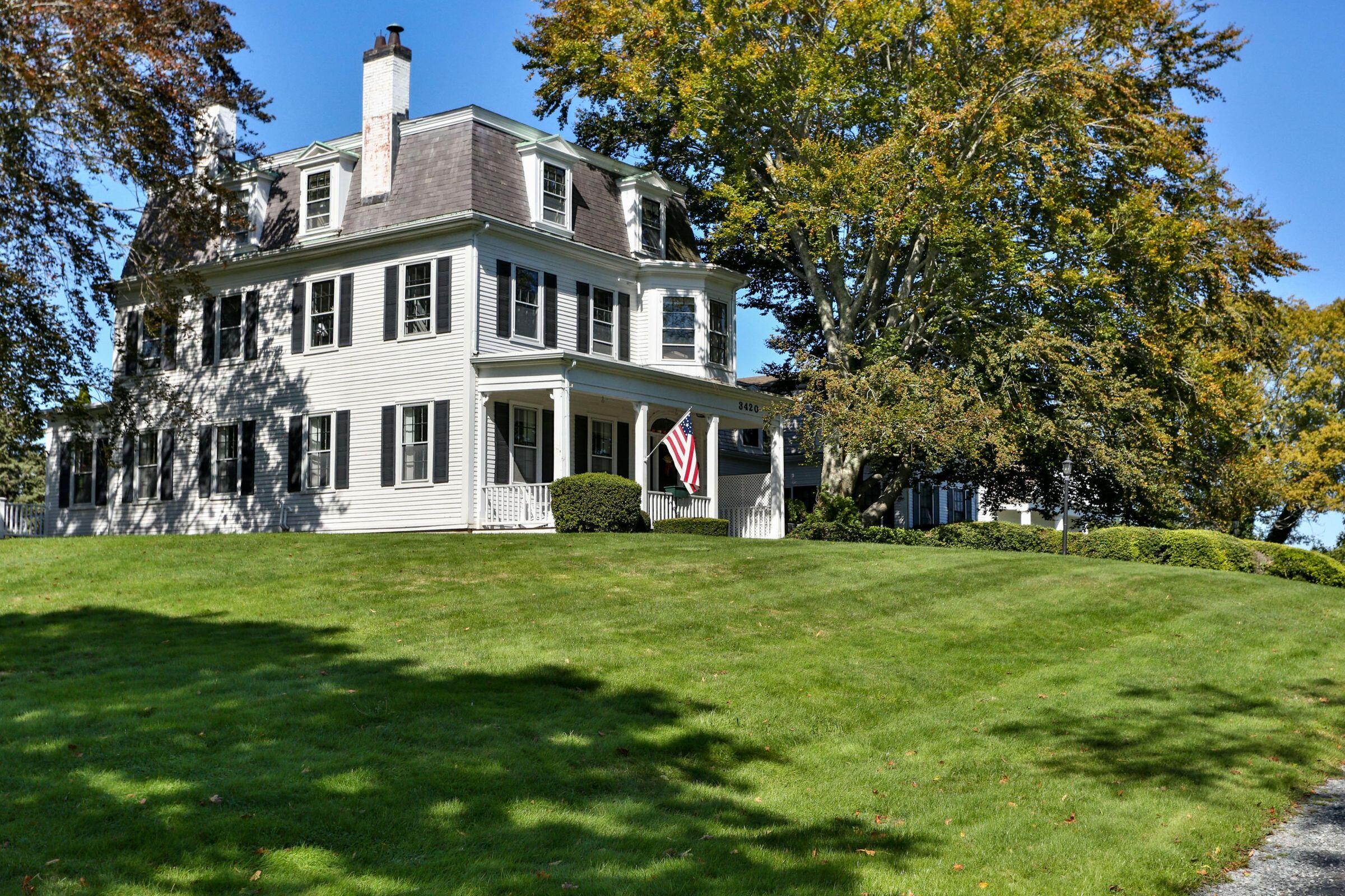 a front view of a house with a garden