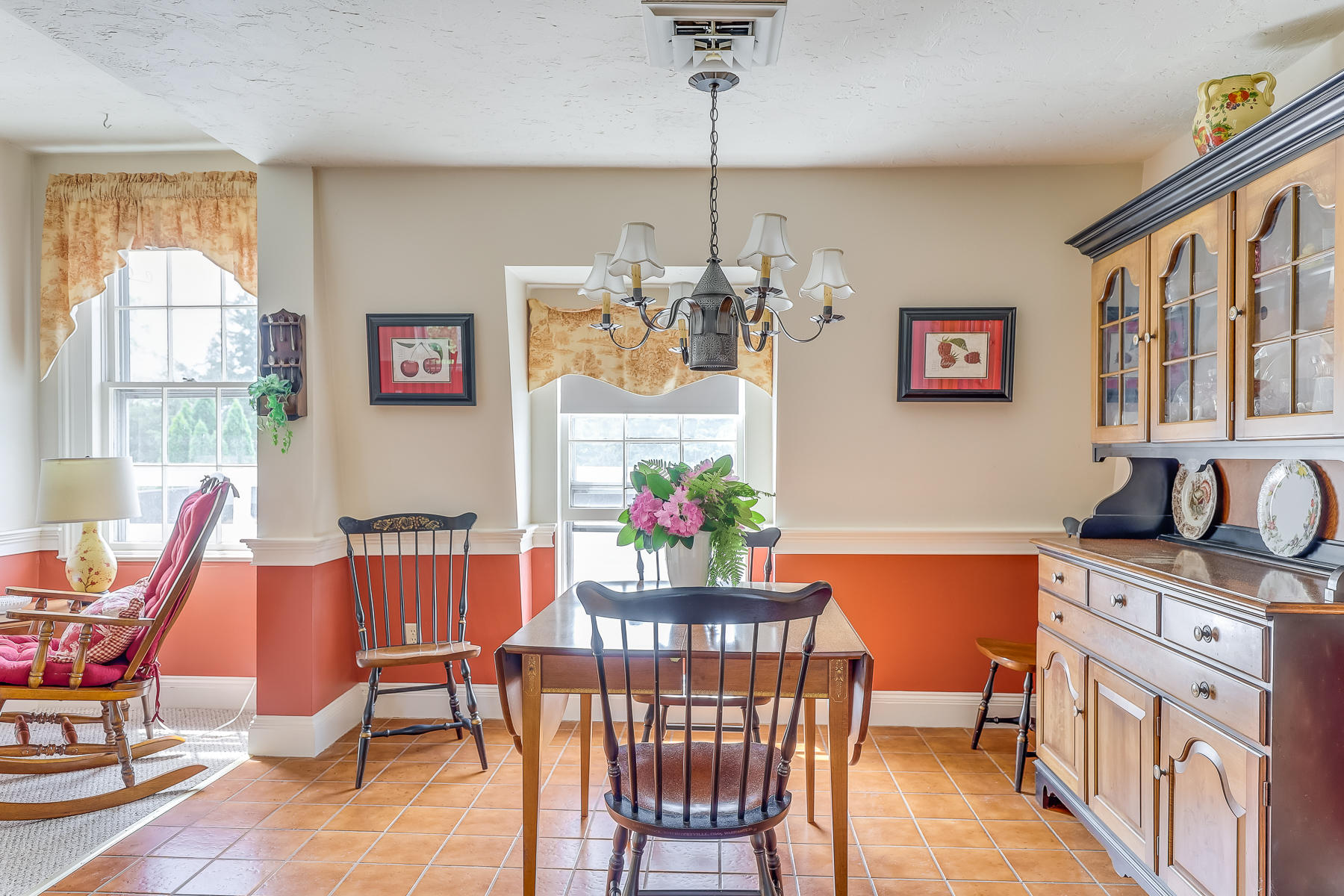 3420 Main Street, Unit 3 Barnstable, MA 02630 - Photo 11 of 28 a view of a dining room with furniture a chandelier and wooden floor