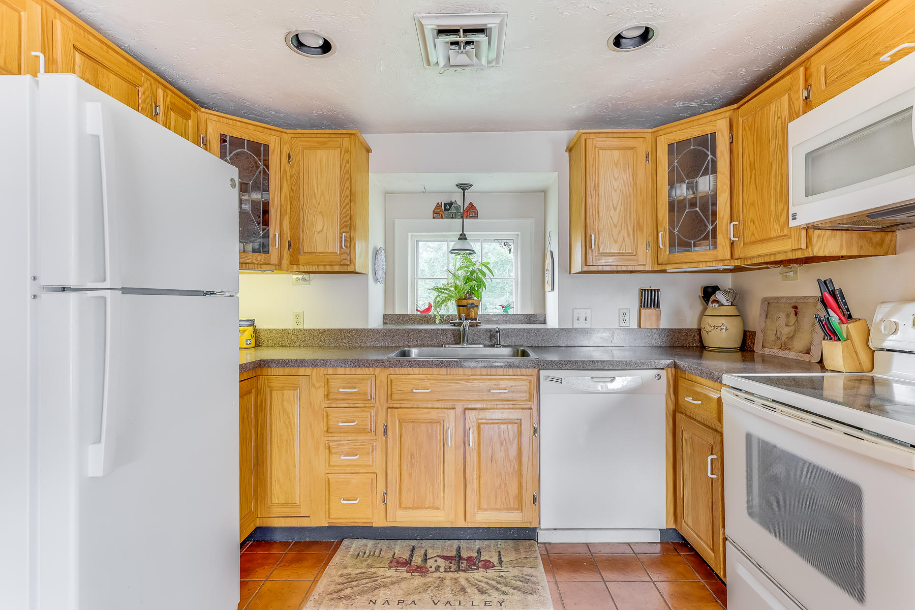 3420 Main Street, Unit 3 Barnstable, MA 02630 - Photo 9 of 28 a kitchen with stainless steel appliances granite countertop a sink and a refrigerator
