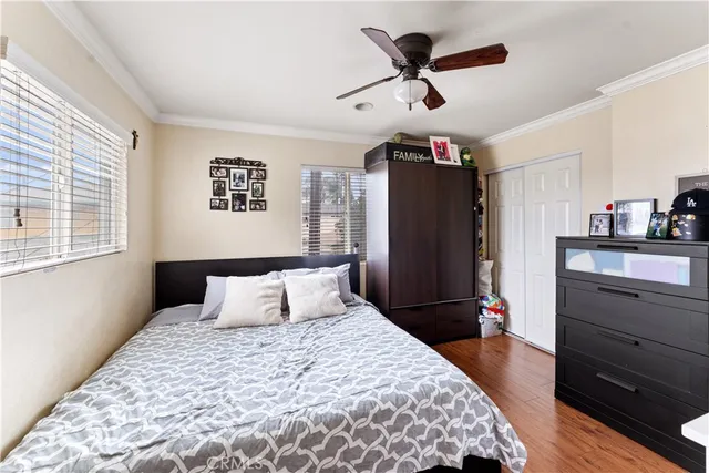 a bedroom with a bed a dresser and a window